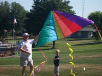 Oxford back pain free grandpa and grandson playing with a kite
